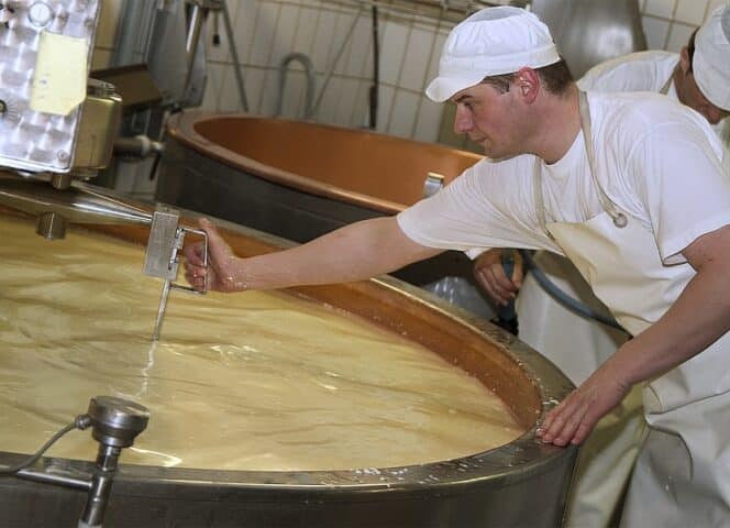 Cheese making by the cheesemaker at the Maison du Gruyère, Pringy, Switzerland.